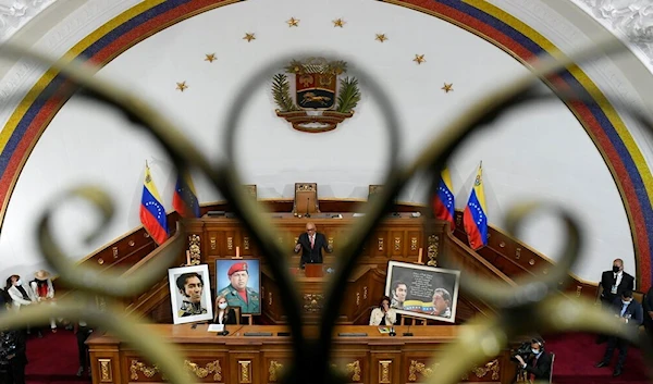 Seen through a balcony gate, the new president of Venezuela's National Assembly Jorge Rodriguez addresses newly sworn-in lawmakers in Caracas, Venezuela, Tuesday, Jan. 5, 2021. (AP)