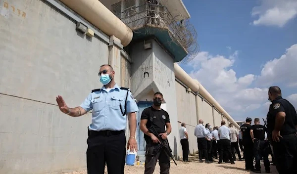 Police officers and prison guards inspect the scene of a prison escape outside the Gilboa prison in northern occupied Palestine 6 September 2021(AP)