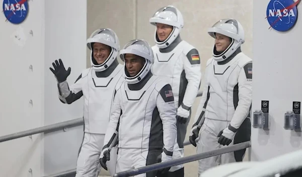 Astronauts walk out of the Operations and Checkout Building on their way to the SpaceX Falcon 9 rocket with the Crew Dragon spacecraft on launch pad 39A at the Kennedy Space Center on November 10, 2021 (AFP)