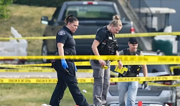 Investigators look over the scene of an overnight shooting at a strip mall in Willowbrook, Ill., June 2023. (AP)