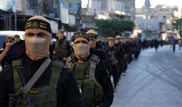 Masked members of the Palestinian Al-Quds Brigades, the military wing of the Islamic Jihad group marching during a rally along the street of Rafah refugee camp, southern Gaza Strip, August 9, 2023 (AP)