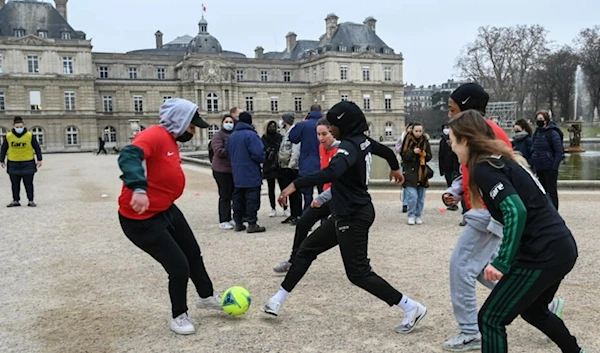 Women calling themselves the "Hidjabers" play football in the Luxembourg garden facing the French Senate in Paris on January 26, 2022. (AFP)