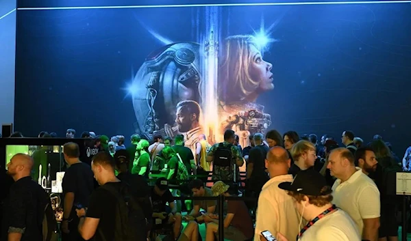 Visitors wait for a Starfield event at the Gamescom Xbox booth 24 August 2023 (AP)