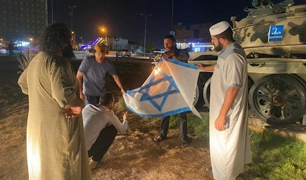 Libyan protestors setting fire to the Israeli flag in Al-Zawiya, Libya, August 28, 2023 (Social Media)