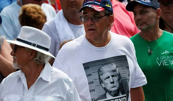 A shirt displaying a fake mug shot of the former president and 2024 presidential candidate Donald Trump is seen during a campaign rally in Pickens, S.C., in July, 2023. (AFP)