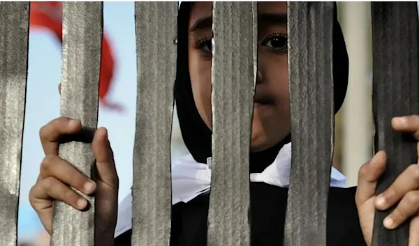 A Bahraini woman during an anti-government rally in solidarity with jailed political prisoners in the village of A’ali, 27 June 2013. (AFP via Getty Images)