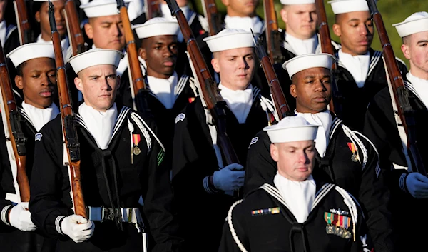 A ceremonial US Navy unit marches in before President Joe Biden welcomes French President Emmanuel Macron during a State Arrival Ceremony on the South Lawn of the White House in Washington, Dec. 1, 2022 (AP)