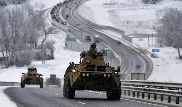 A convoy of Russian armored vehicles moves along a highway in Crimea, Tuesday, Jan. 18, 2022 (AP Photo, File)