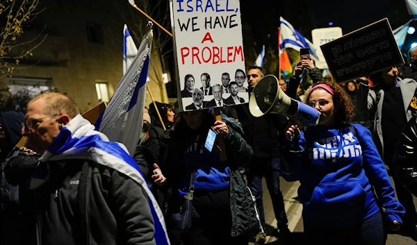 Israelis protest against the plans by Prime Minister Benjamin Netanyahu's new government to overhaul the judicial system, in occupied Palestine, February 9, 2023 (AP)