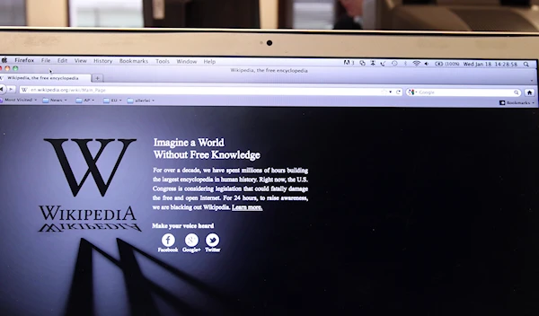 The webpage of the encyclopedia website Wikipedia shows a stark black-and-white page with the message: "Imagine a world without free knowledge", at an office in Brussels, Wednesday, Jan. 18, 2012 (AP Photo/Yves Logghe)