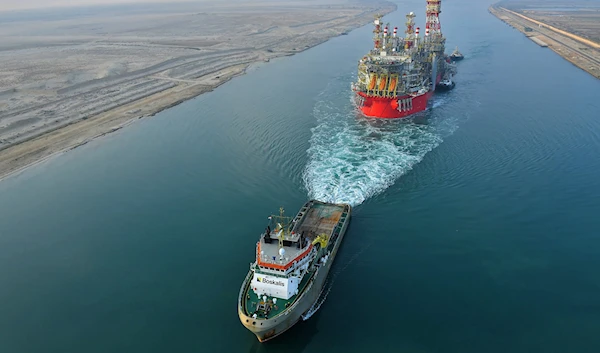 A tugboat pulling an Energean floating production storage and offloading (FPSO) ship along Egypt's Suez Canal, June 3, 2022. (AFP)