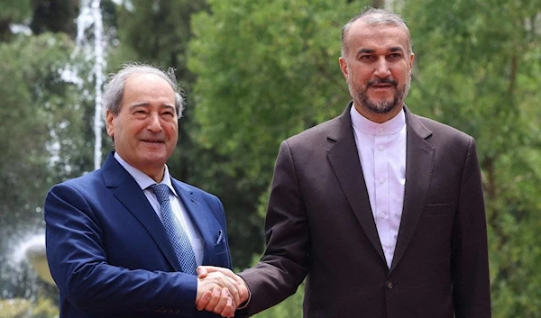 Iranian Foreign Minister Hossein Amir-Abdollahian welcomes his Syrian counterpart Faisal Al-Miqdad in Tehran. (AFP)