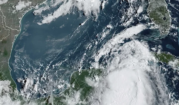 Tropical Storm Idalia moves between Mexico's Yucatan Peninsula, left, and Cuba, right, at 9:40 a.m. ET. NOAA via AP