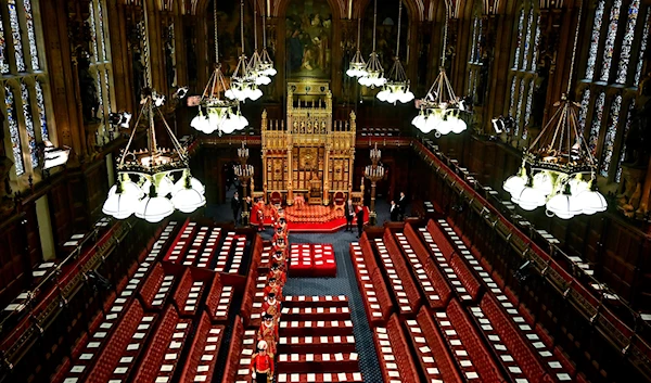 Yeoman of the Guard walk among the seats in the House of Lords Chamber, during the State Opening of Parliament, in the Houses of Parliament, in London, Tuesday, May 10, 2022. (AP)