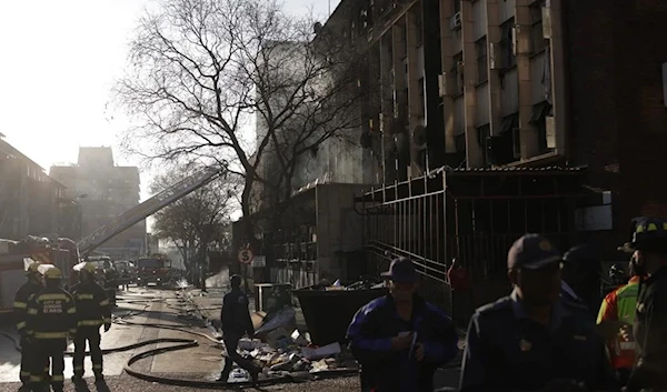 A photo of firefighters at the scene of the fire in Johannesburg, South Africa on August 31, 2023 (AFP)