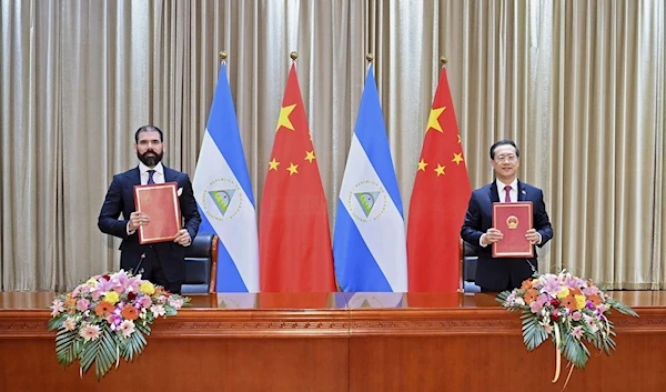 Laureano Ortega Murillo, son of and advisor to Nicaraguan President Daniel Ortega, left, and Chinese Vice Foreign Minister Ma Zhaoxu in 2021 (AP)