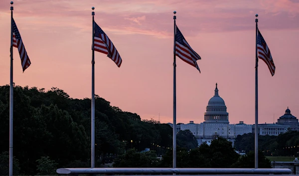 The U.S. Capitol building is seen from the base of the Washington Monument as the sun rises in Washington, D.C., U.S., May 28, 2023. (AFP)