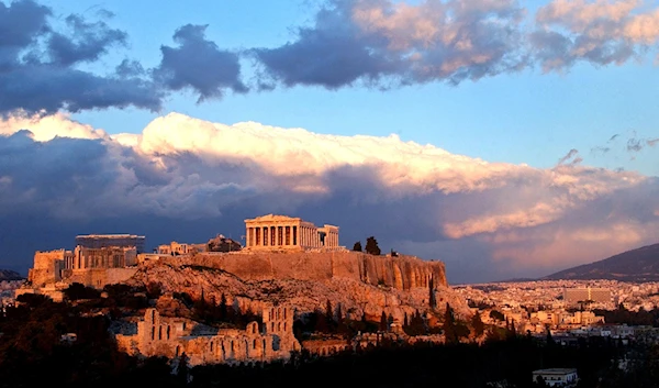 Sunlight catches clouds behind the ancient Acropolis in Athens on Tuesday, Feb. 3, 2004. (AP)