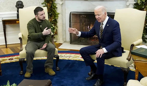 President Joe Biden speaks with Ukrainian President Volodymyr Zelensky in the Oval office of the White House, in December 21, 2022. (AP)