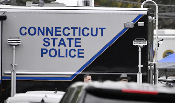 Members of the Connecticut State Police Major Crime Unit on scene where two police officers were killed, Oct. 13, 2022, in Bristol, Conn. (AP)