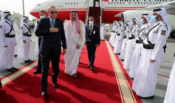 Turkey's President Recep Tayyip Erdogan, left, inspects Qatari honour guard at Doha Airport, in Doha, Qatar, Thursday, July 2, 2020, before a meeting with Emir of Qatar Sheikh Tamim bin Hamad Al Thani. (AP)