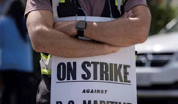 International Longshore and Warehouse Union workers picket outside of the BC Maritime Employers Association Dispatch Center after a 72 hour strike notice and no agreement made on the bargaining table in Vancouver, on Saturday, July 1, 2023. (AP)