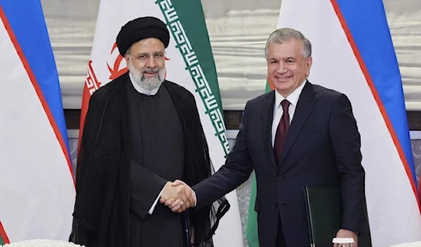 Uzbekistan President Shavkat Mirziyoyev and Iranian counterpart Ebrahim Raisi in September 2022 during their meeting in Samarkand, Uzbekistan (AP)