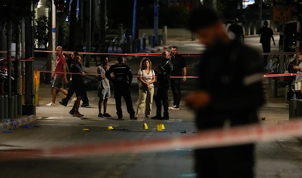 Israeli occupation police inspect the site of a shooting attack in "Tel Aviv", "Israel", Saturday, Aug 5, 2023 (AP)