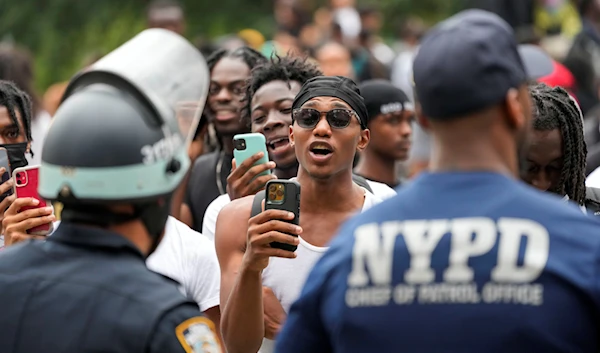 People film police officers as they chant anti-NYPD slogans, Friday, August 4, 2023, in New York's Times Square (AP)