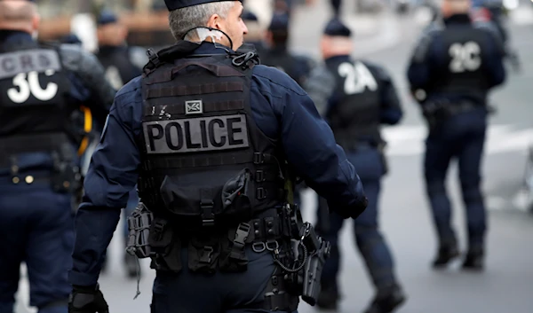 Policemen stand guard during a demonstration of students in Paris, Tuesday, Dec. 18, 2018. (AP)