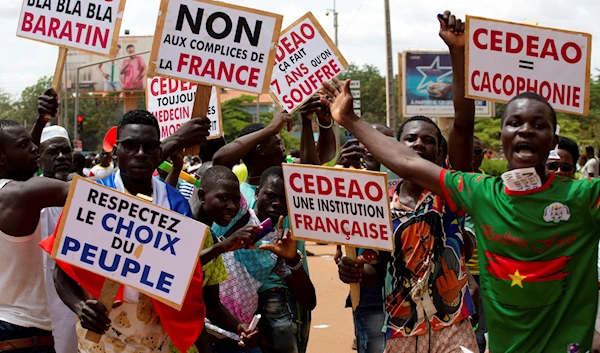 Supporters of Captain Ibrahim Traore protest against France and ECOWAS in the streets of Ouagadougou, Burkina Faso October 4, 2022 (AP)