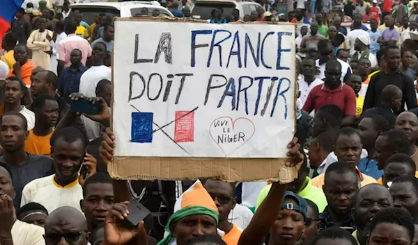 Banner reads "France must leave" during pro-junta protests in Niger. (AFP)