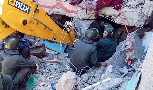 Rescue workers search for survivors in a collapsed house in Moulay Brahim in Morocco's Al-Haouz province (AFP)