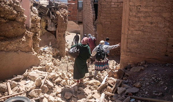 Residents flee their homes after an earthquake in Moulay Brahim village, near the epicenter of the earthquake, outside Marrakech, Morocco, September 9, 2023. (AP)