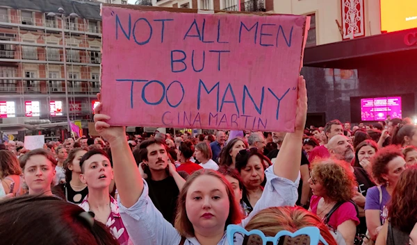 A woman holds a placard as demonstrators gather in the center of Madrid, Spain, Aug. 28, 2023, for an anti-Rubiales protest and to support Spain's national womens's soccer team player Jenni Hermoso (AP)