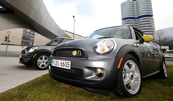 Two BMW Mini electric vehicles are parked near the main factory in Munich on Friday, November 28, 2008 (AP Photo/Christof Stache)