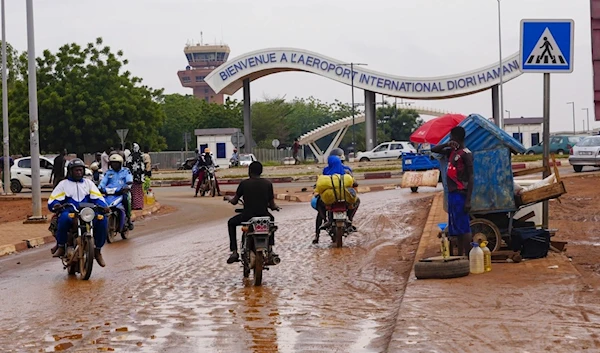 Motorcyclists ride by the entrance of the airport in Niamey, Niger, August 8, 2023. (AP)