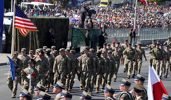 Representatives of allied US troops march in a massive military parade that was to show NATO member Poland's defense potential in Warsaw, Poland, 15 August 2023 (AP)