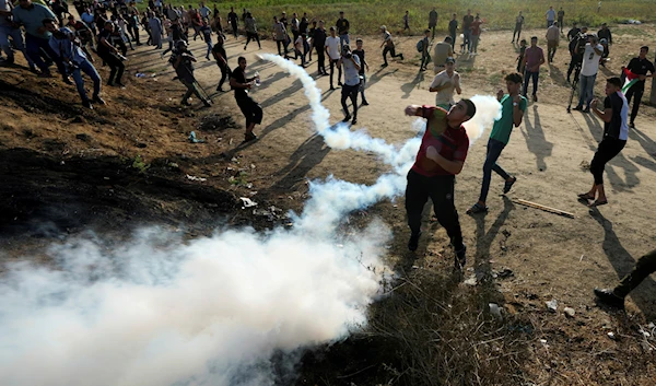 Palestinian protesters clash with Israeli occupation forces along the Gaza border during a demonstration marking the Israeli occupation's withdrawal from Gaza in 2005, east of Gaza City, Sept. 13, 2023 (AP)