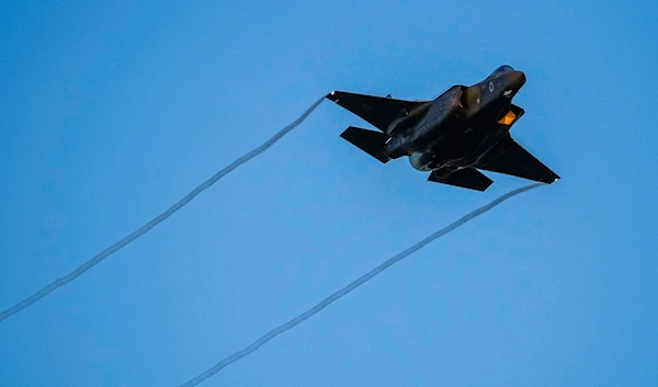 An Israeli air force F-35 war plane flies over during a graduation ceremony for new pilots in Hatzerim air force base near the southern Palestinian city of Beer Al-Sabe, occupied Palestine,. June 29, 2023 (AP)