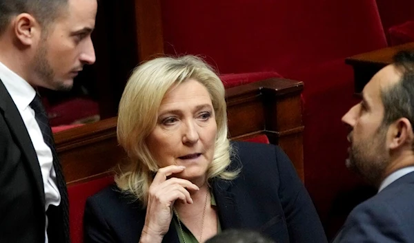 French far-right leader Marine Le Pen talks with National Rally group members at the National Assembly, Monday, Feb. 6, 2023 in Paris (AP Photo/Christophe Ena)