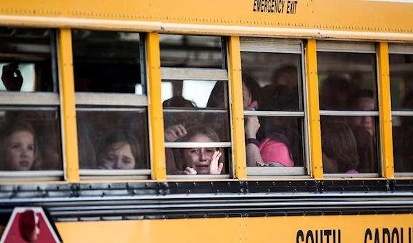 Students at Townville Elementary in South Carolina cry after a gunman opened fire on the playground in 2016 (AP)