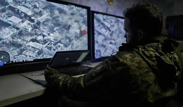 In this photo from December 25, 2022, a Ukrainian soldier watches a drone feed from an underground command centre in Bakhmut, in the Donetsk region (AP)