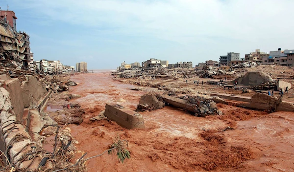 People look at the damage caused by floods in Derna, eastern Libya, on Sept. 11, 2023 (AFP)