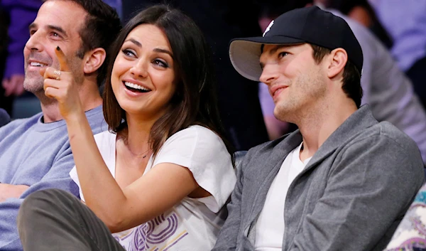 Actress Mila Kunis, left, and actor Ashton Kutcher, right, sit courtside together at the NBA basketball game between the Phoenix Suns and Los Angeles Lakers on Tuesday, February 12, 2013, in Los Angeles. (AP)