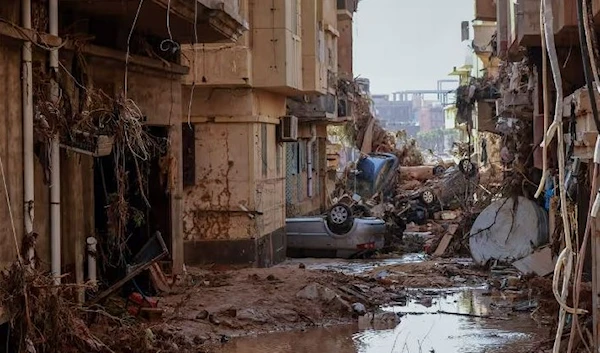 Overturned cars lay among other debris caused by flash floods in Derna, eastern Libya (AFP via Getty Images)