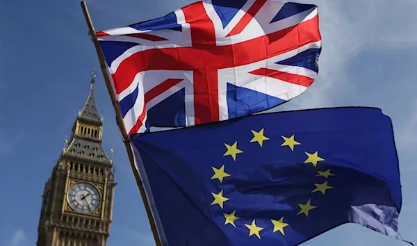 File photo of an EU flag and a Union flag seen with Elizabeth Tower (Big Ben) and the Houses of Parliament in London taken on March 25, 2017 (AFP)