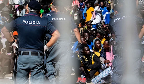 Migrants gather outside the operational center on the Italian island of Lampedusa on Sept. 14, 2023. (AFP)