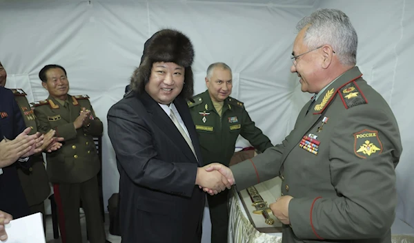 DPRK's Kim Jong Un is pictured receiving a gift from Russian Defense Minister Sergei Shoigu during a visit in Vladivostok, Sept. 16, 2023. (AP)