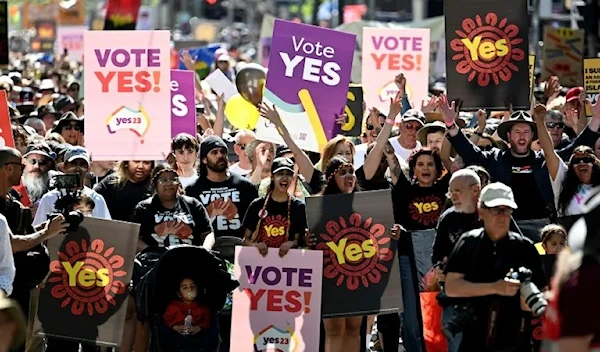 Crowds hold up banners during a "Walk for Yes" rally in Melbourne ahead of the referendum on September 16, 2023 (AP)